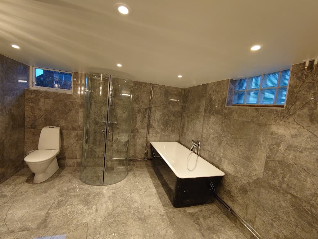 Badrum med dusch och badkar efter renovering